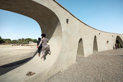 Children playing in the wall holes. | Courtesy of architect / Deed Studio (photographer)