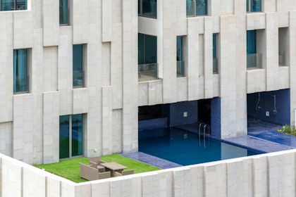 The tower rises from a plinth that contains public areas, including a pool and a gym. | Aga Khan Trust for Culture / Cemal Emden (photographer)